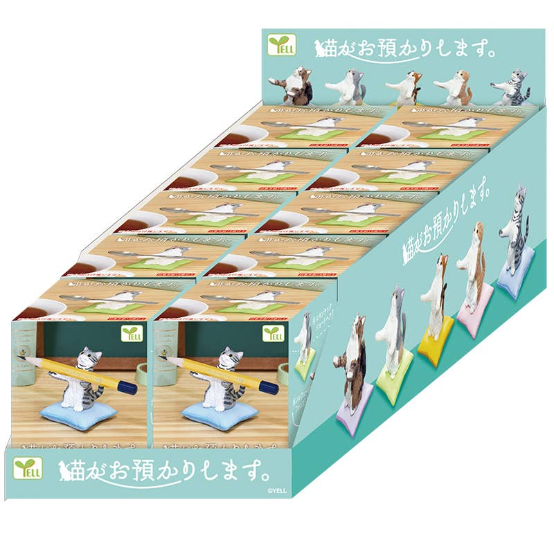 Set of cat-themed stationery items including figurines and desk accessories on a display stand.