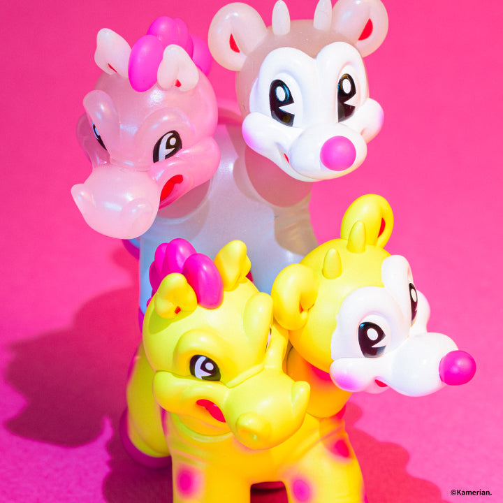 Close-up of Luminous and Yellow UMASHIKA figures on a pink background