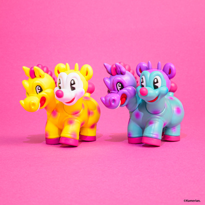 Yellow and Purple-Turquoise UMASHIKA figures shown together from the front