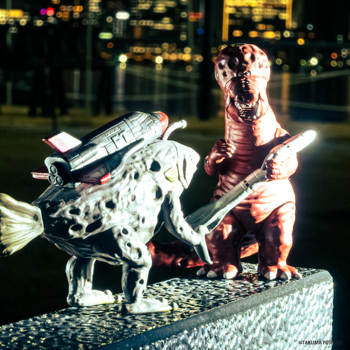 Tokyo Kaiju Universe Vol. 1 and Vol. 2 kaiju figures posed together in a nighttime city scene
